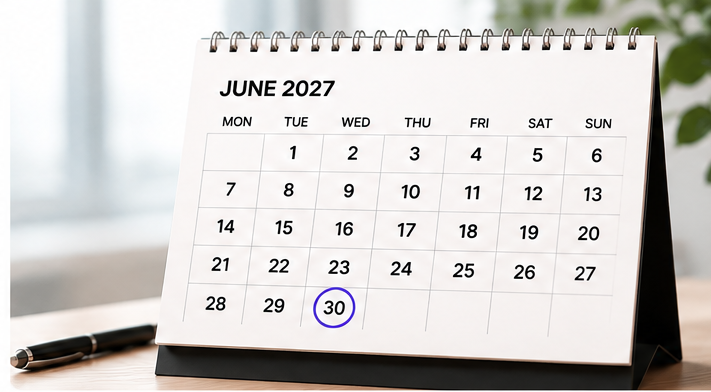 Desk calendar open at June 2027 with the thirtieth circled